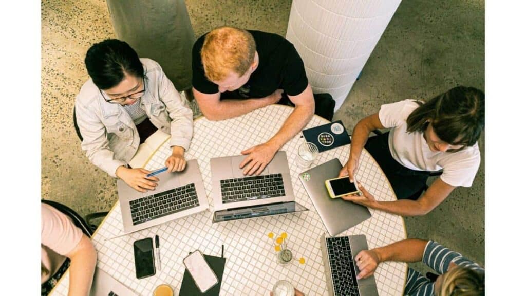 group sitting around a computer