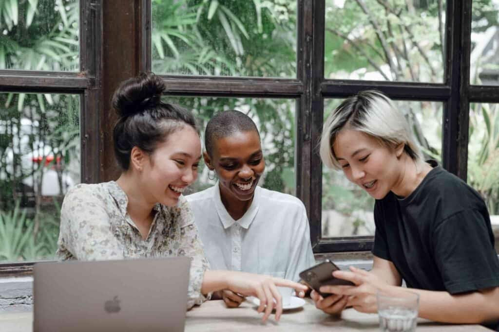 ladies sitting around a computer