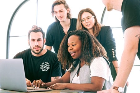 a team of experts at a computer