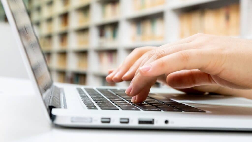 person typing on a mac