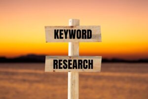 Keyword research message written on wooden sign
