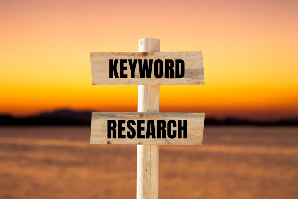Keyword research message written on wooden sign