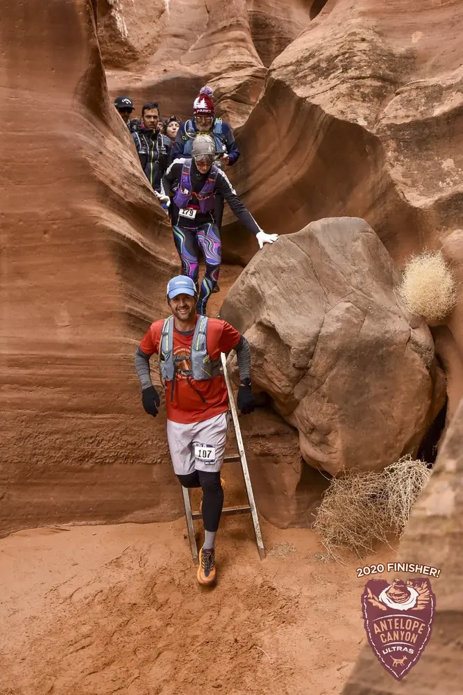 Trail runners moving through a red-rock canyon