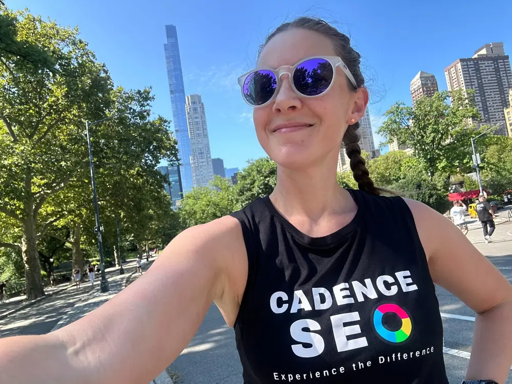 Cadence SEO team member wearing a branded shirt in a city park